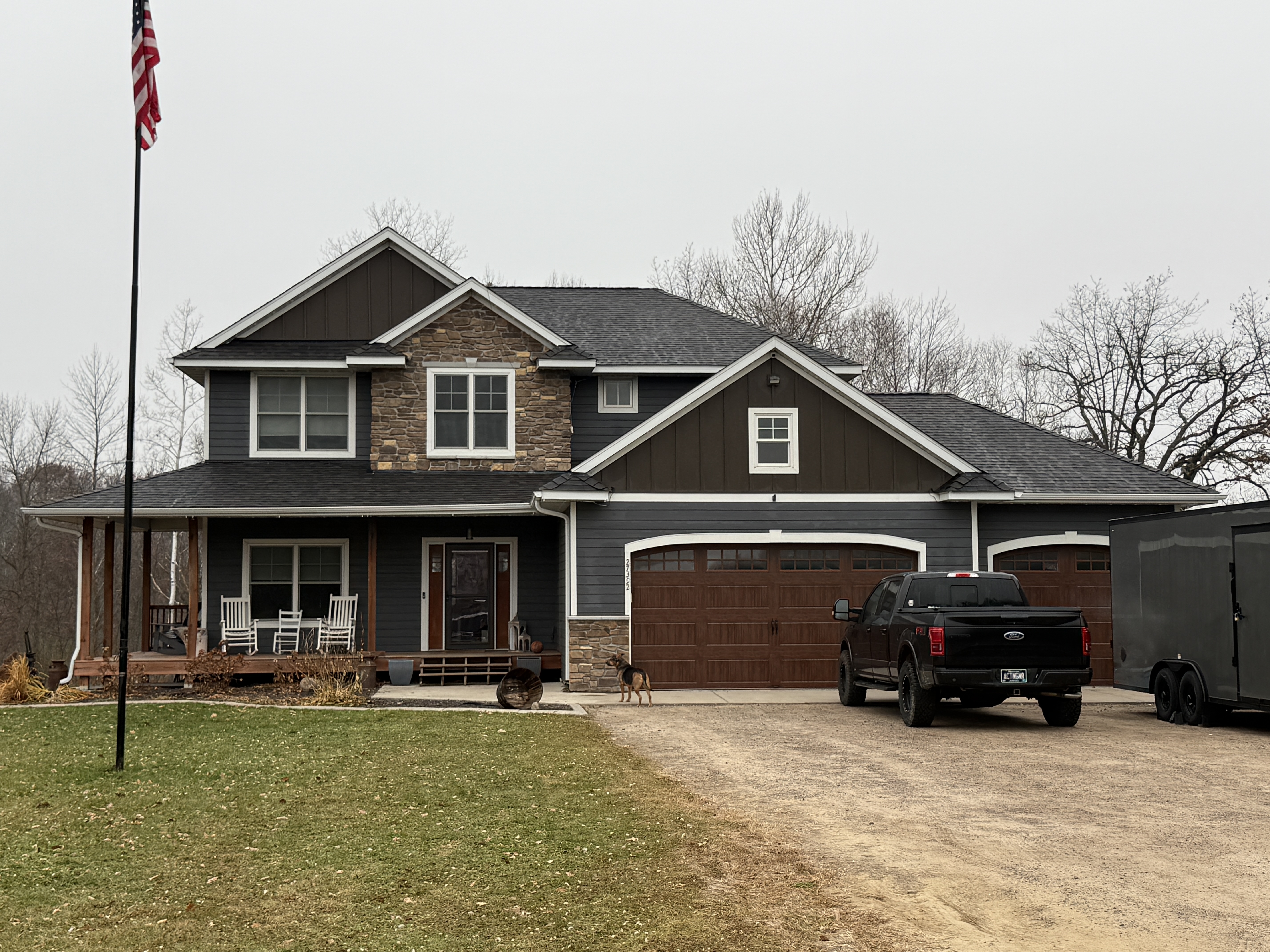 Two-story home with blue-gray siding and a new roof