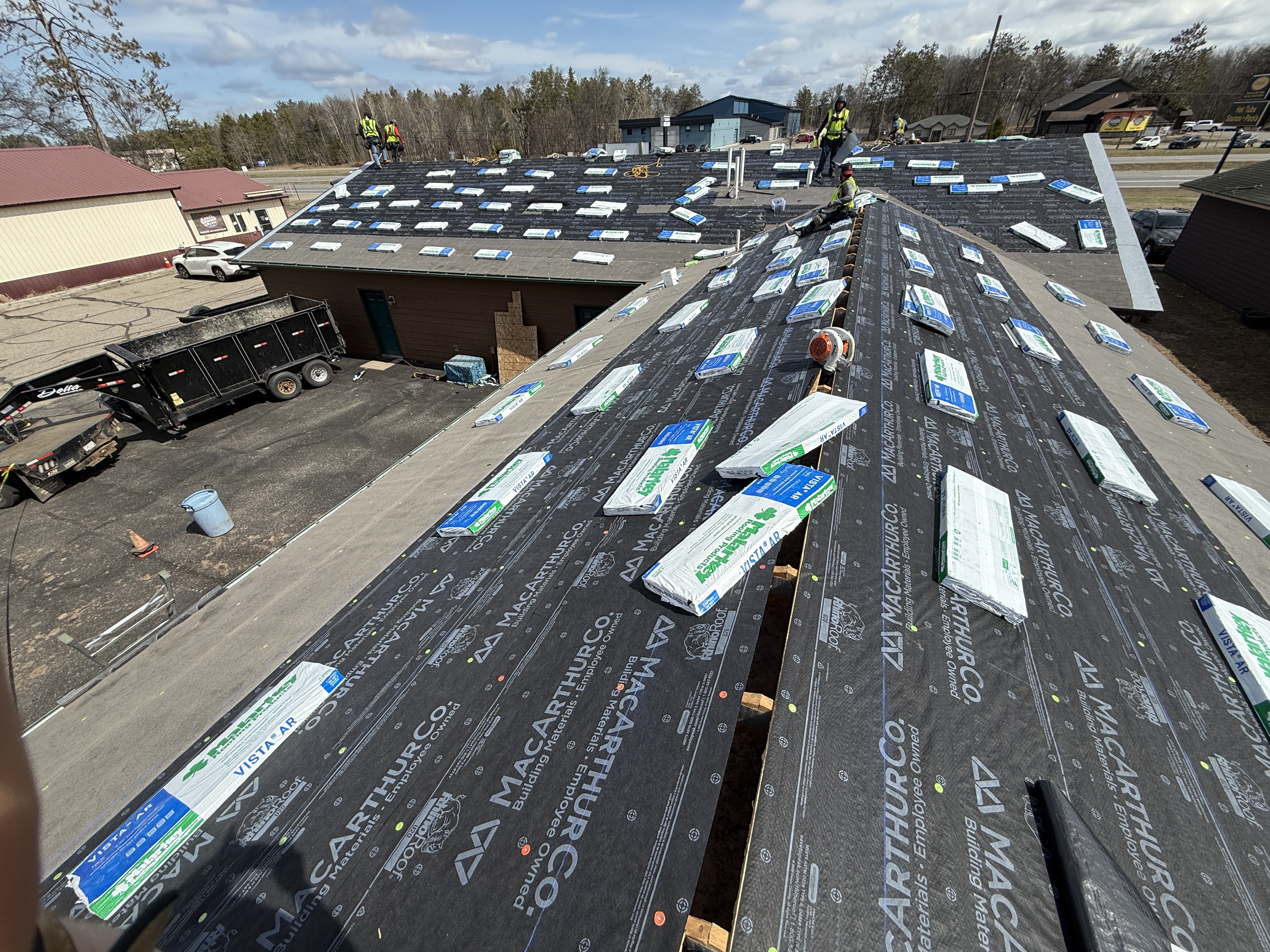New asphalt shingles being installed over underlayment
