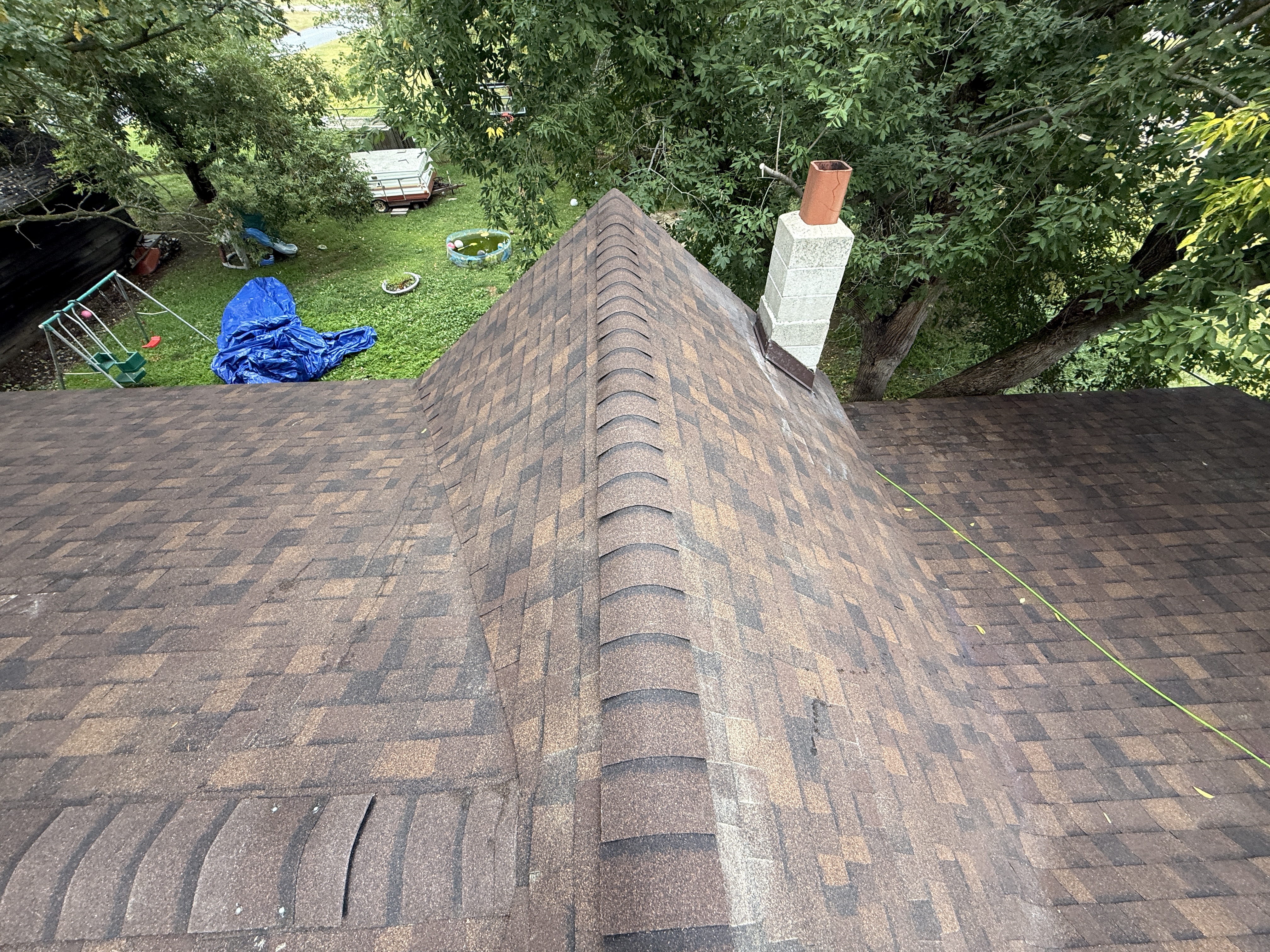 New brown architectural shingle roof with ridge vent